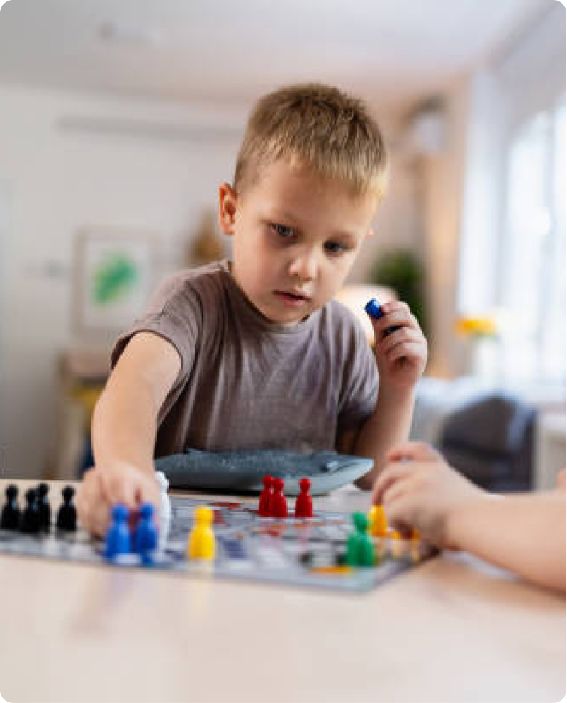 A child concentrating on a colourful creation