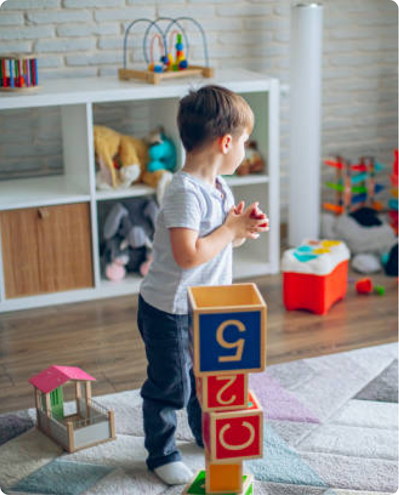 A child building a tall block tower